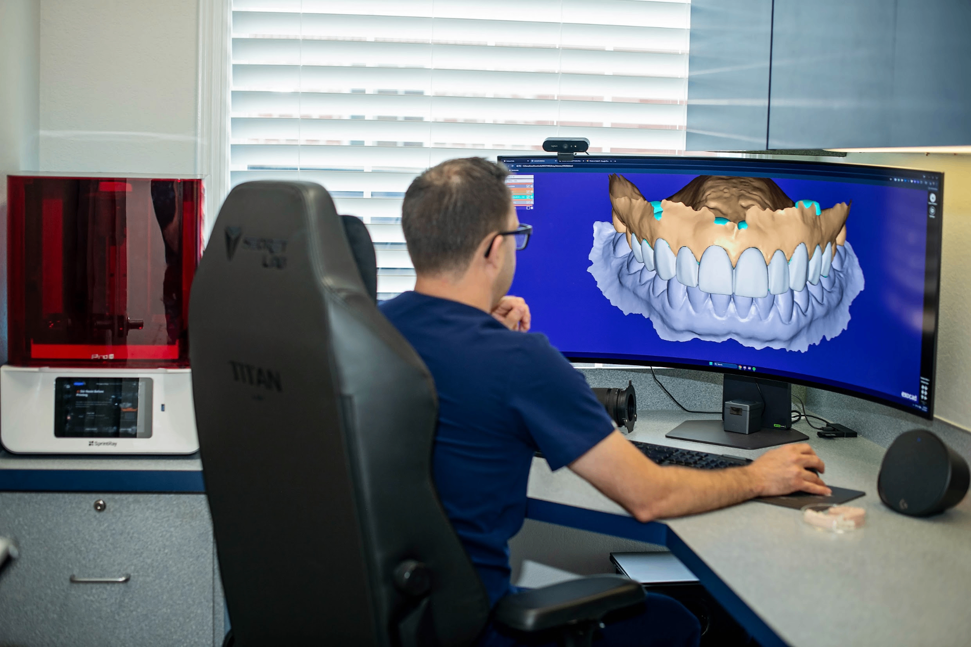 Dr. Prentice using Exocad software to design full-mouth reconstruction with 3D dental models